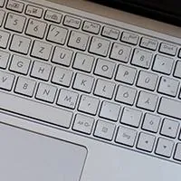 piggy bank with change next to laptop