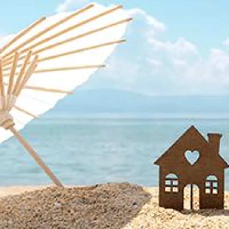 umbrella and miniature house on the beach