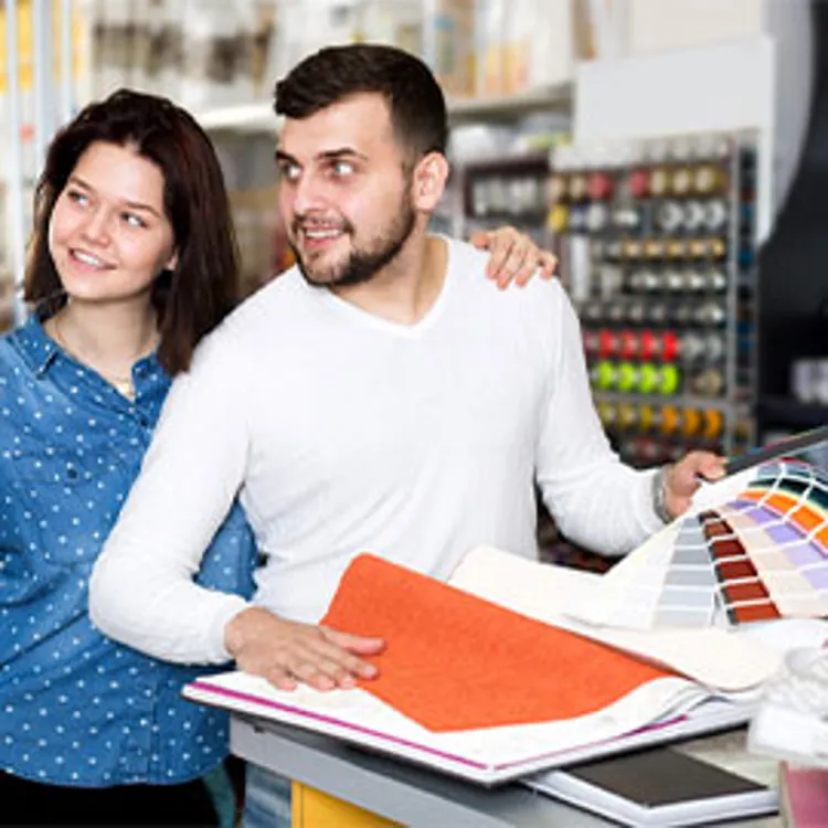 couple choosing a color scheme in a paint store