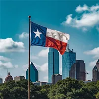 texas flag with buildings in the background