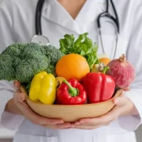 a dietitian holding a bowl of vegetables