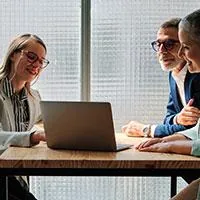 elderly couple talking to financial advisor