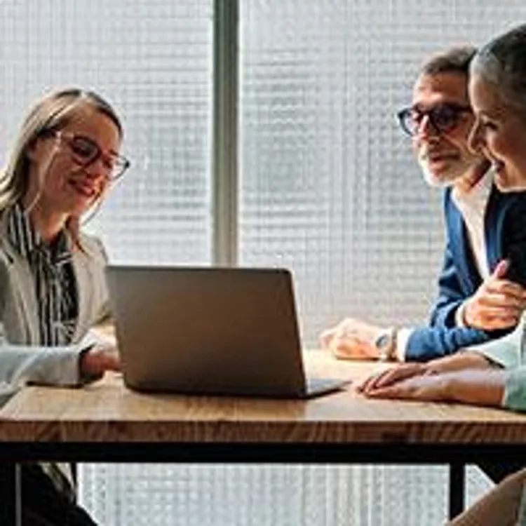 elderly couple talking to financial advisor