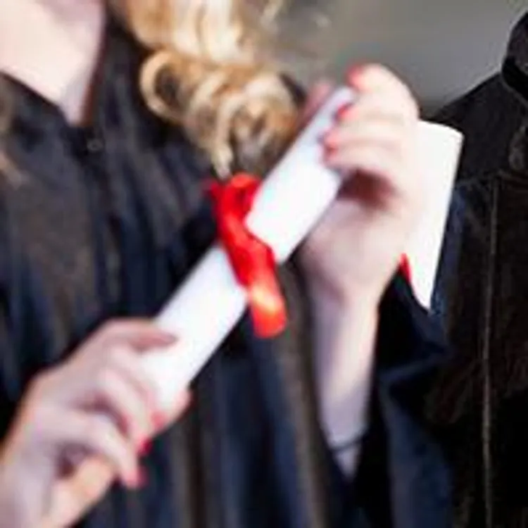 graduates holding diplomas