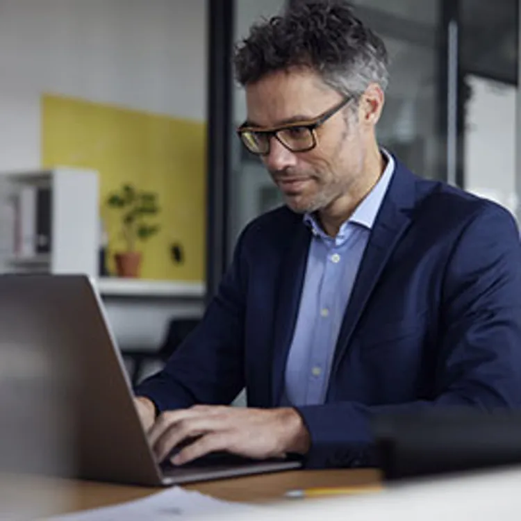 businessman typing on a laptop