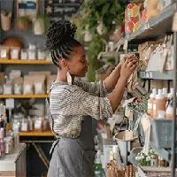 female shopkeeper sorting items in store
