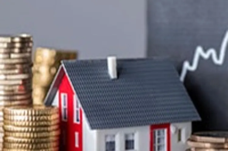 stacks of coins beside model house and upward graph