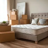 a mattress and a pile of boxes for moving