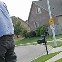 two men moving piano onto truck