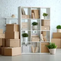 a white multi-tier shelf and a stack of boxes