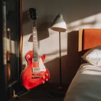 a les paul electric guitar on a guitar stand