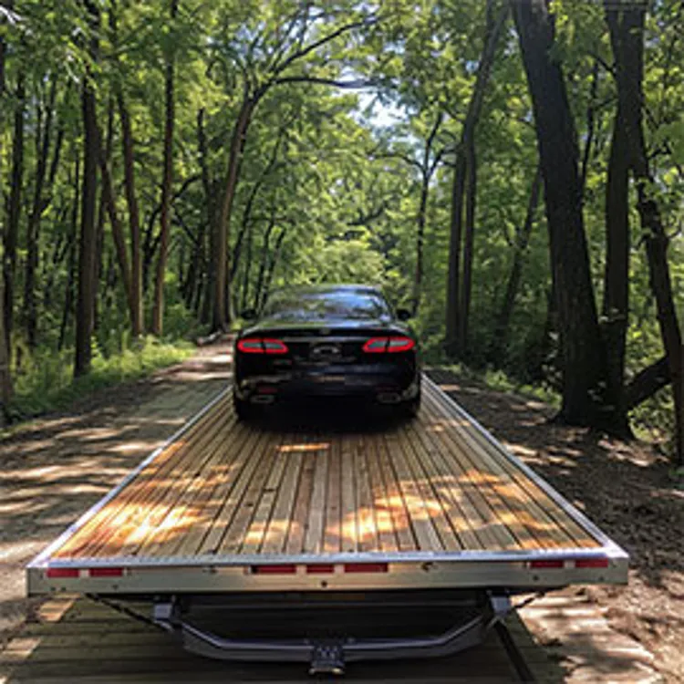 black car on open trailer