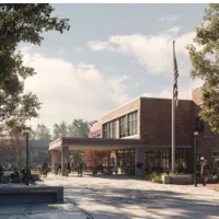 school campus showing entrance to main building with students on the grounds
