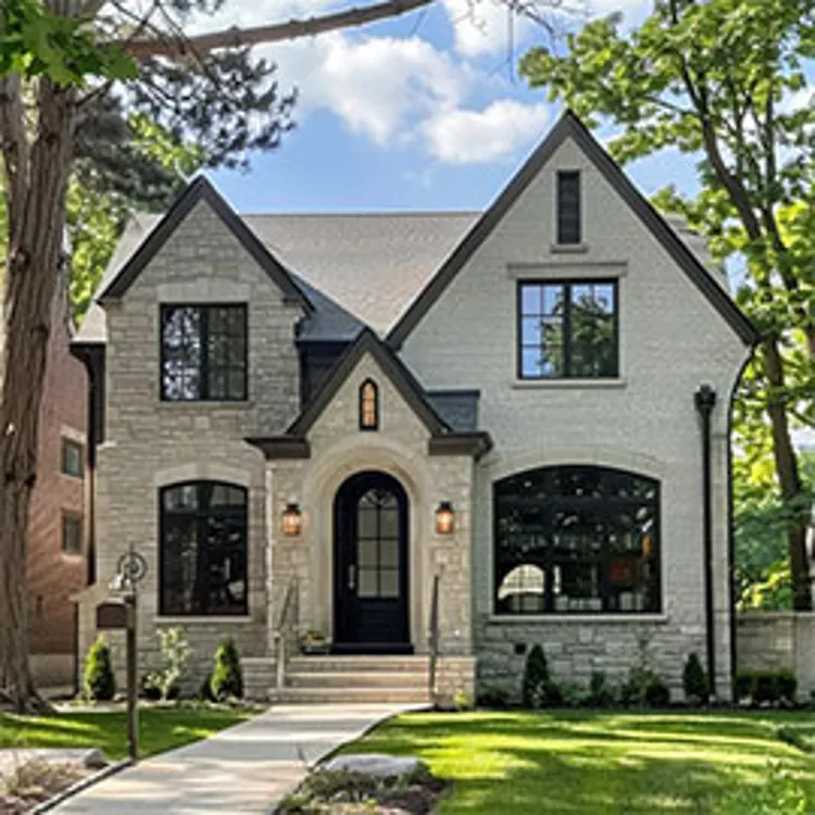 nice two-story white-colored brick home with large windows