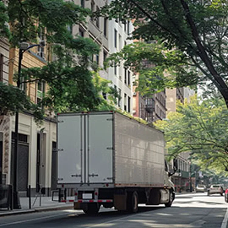 moving truck passing through an urban residential area