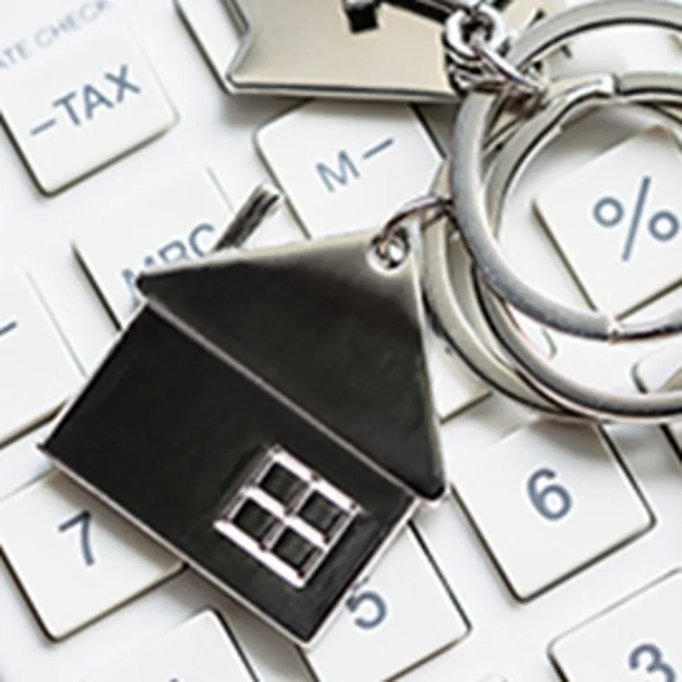 house keychain sitting on a calculator