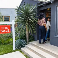 mother and daughter looking at house for sale