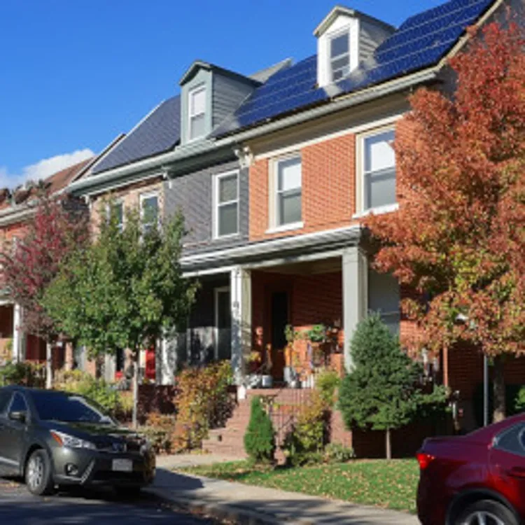 two-story house with solar panels installed on the slanted roof in washington dc