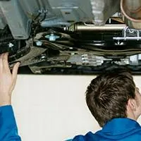 mechanic working underneath a car