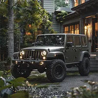 jeep wrangler parked near a house located in a forest