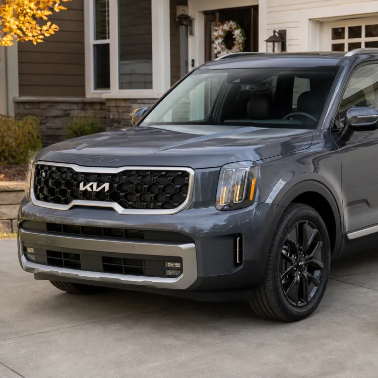 Gray SUV parked on a driveway in front of a garage