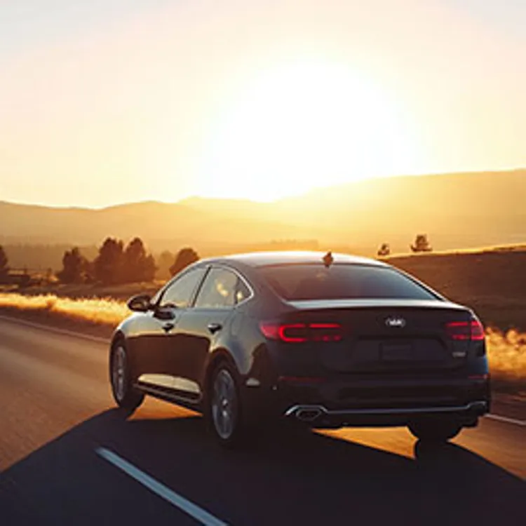 black midsized sedan on the road