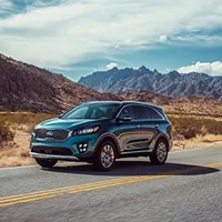 blue suv on a desert road