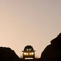 Land Rover driving between mountains