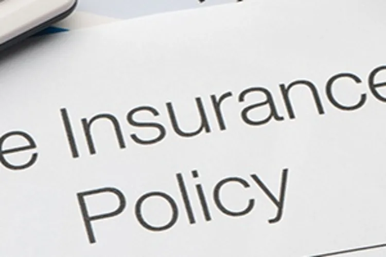 life insurance policy with calculator and glasses