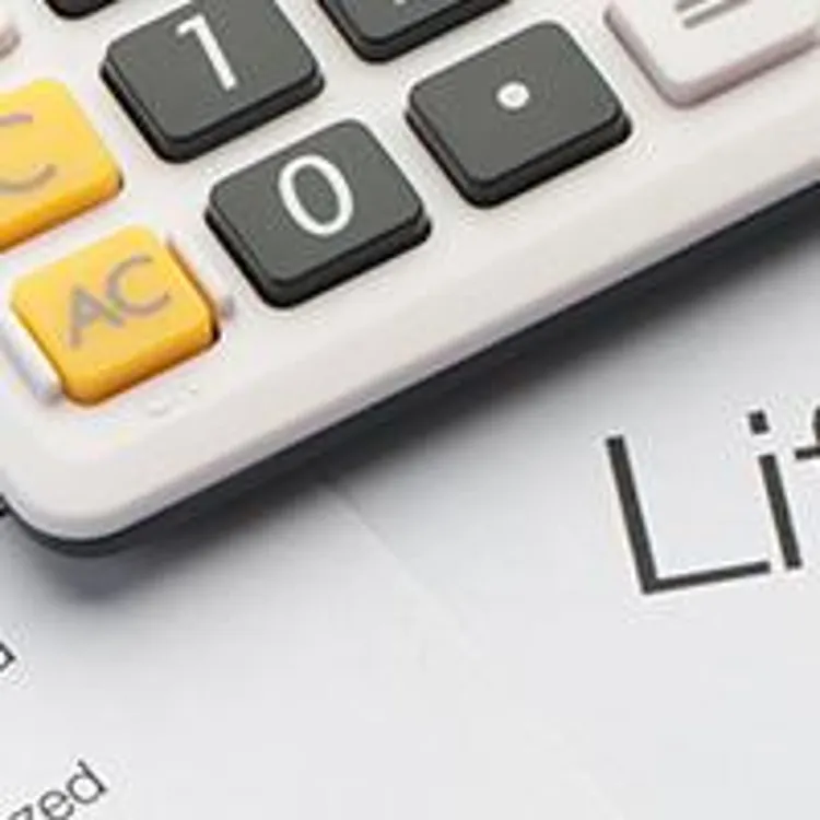 life insurance policy with calculator and glasses
