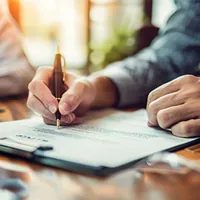 man signing a document
