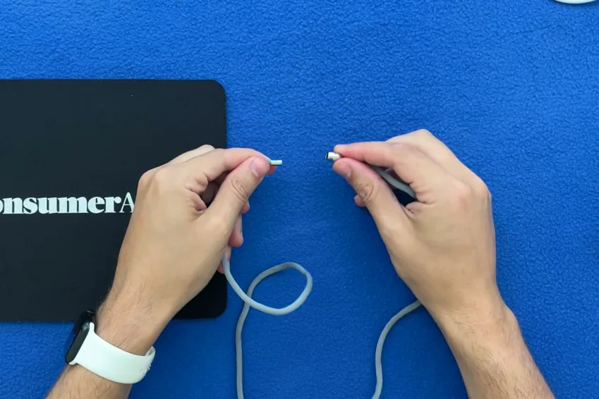 Hands pulling apart the magnetic clasp on the Lifeline On the Go lanyard