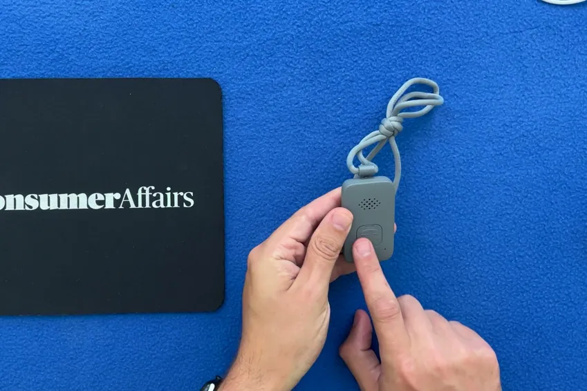 Hands holding the Lifeline On the Go pendant on its lanyard