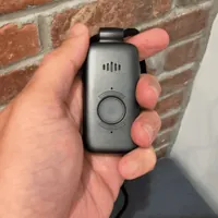 Thumb pressing and holding the Belle X2 help button until it lights blue