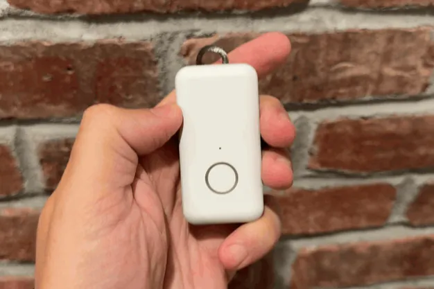 Thumb pressing and holding the Pearl help button until the ring lights up