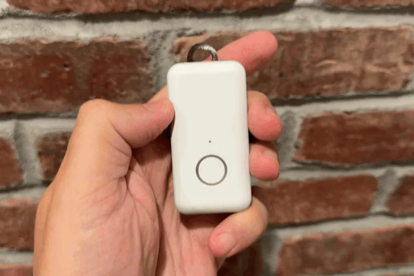 Thumb pressing and holding the Pearl help button until the ring lights up