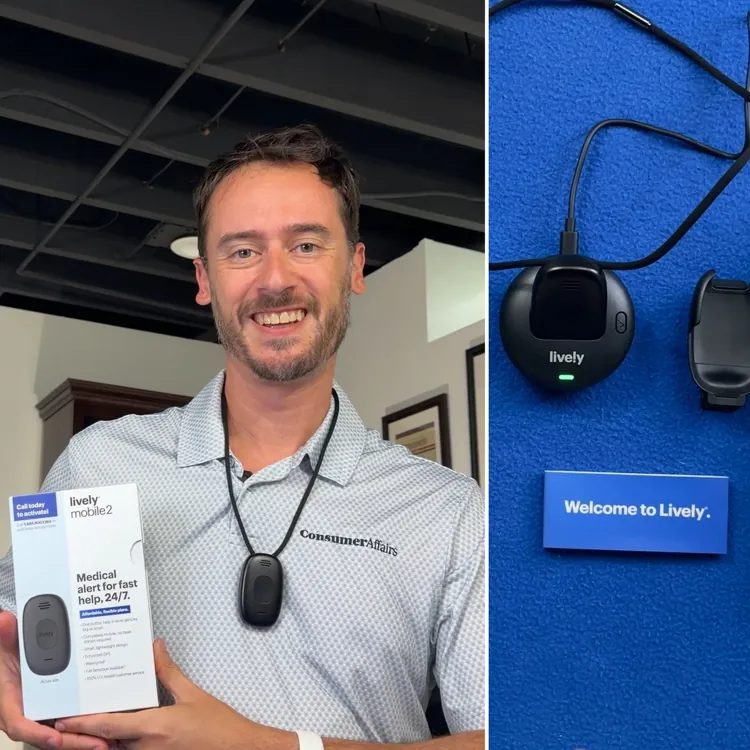 Chris Kolmar holding the Lively Mobile2 box and wearing the pendant beside the system: pendant in its charging dock, belt clip and box