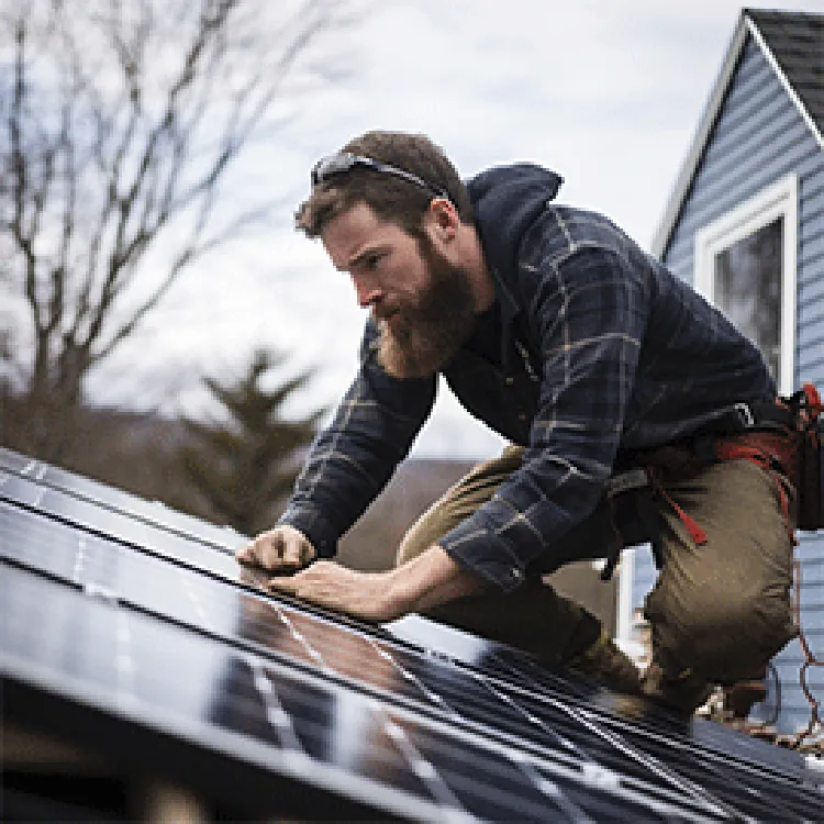 tech installing solar panels