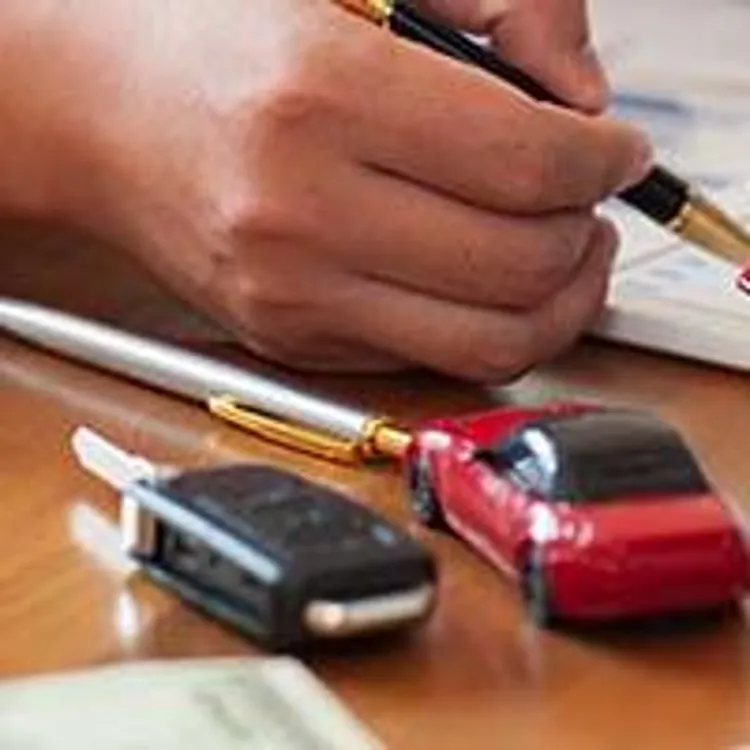 man calculating near model home and car