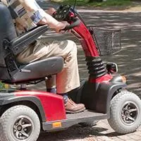 man driving mobility scooter