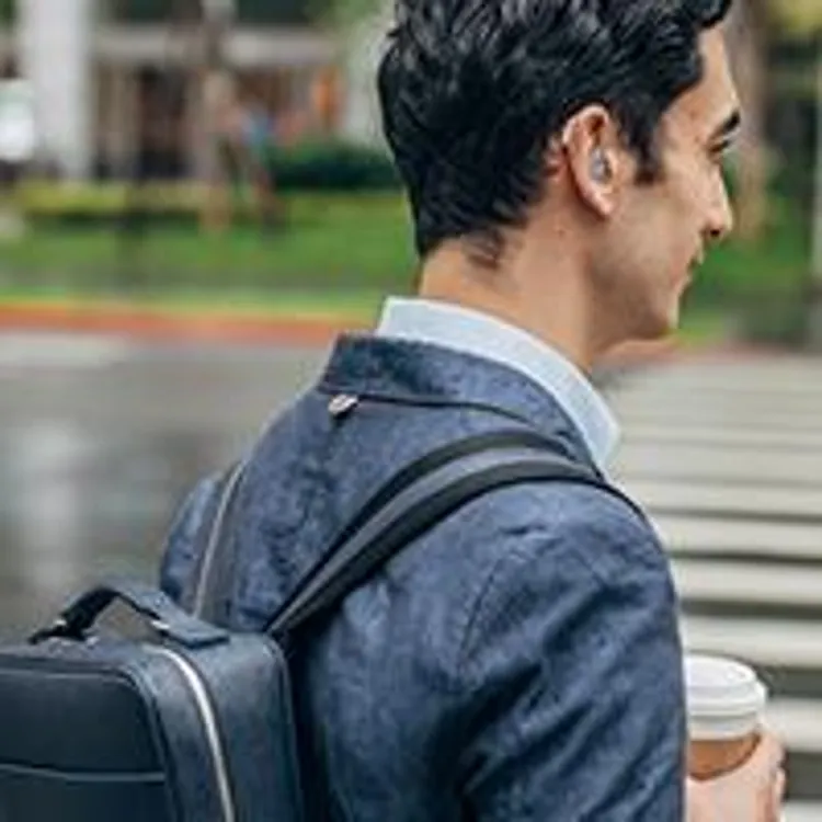 man with hearing aid walking