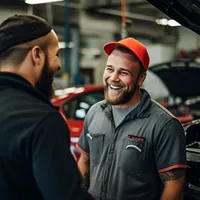 customer talking to a smiling mechanic
