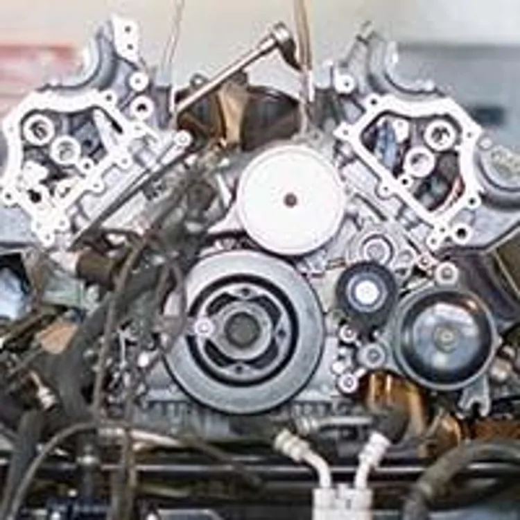 mechanics working on car engine