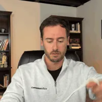 Chris Kolmar pulling the MGMini lanyard over his head and settling the pendant on his chest