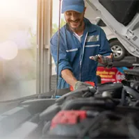 auto mechanic inspecting car engine
