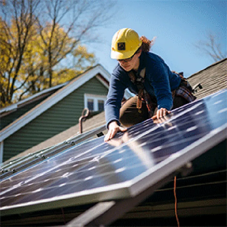 female technician installing solar panels