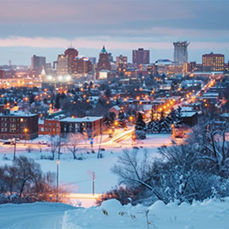 homes with lights on in a minnesota town during winter