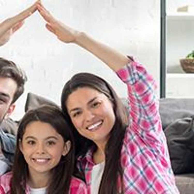 mom and dad creating roof over daughter