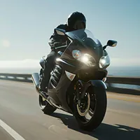 a motorcycle driving down a coastal highway