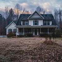 two-story house with dark roof in winter